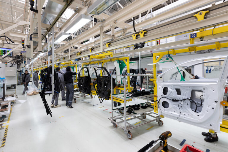 Interior de una planta moderna de ensamblaje automotriz con línea de producción